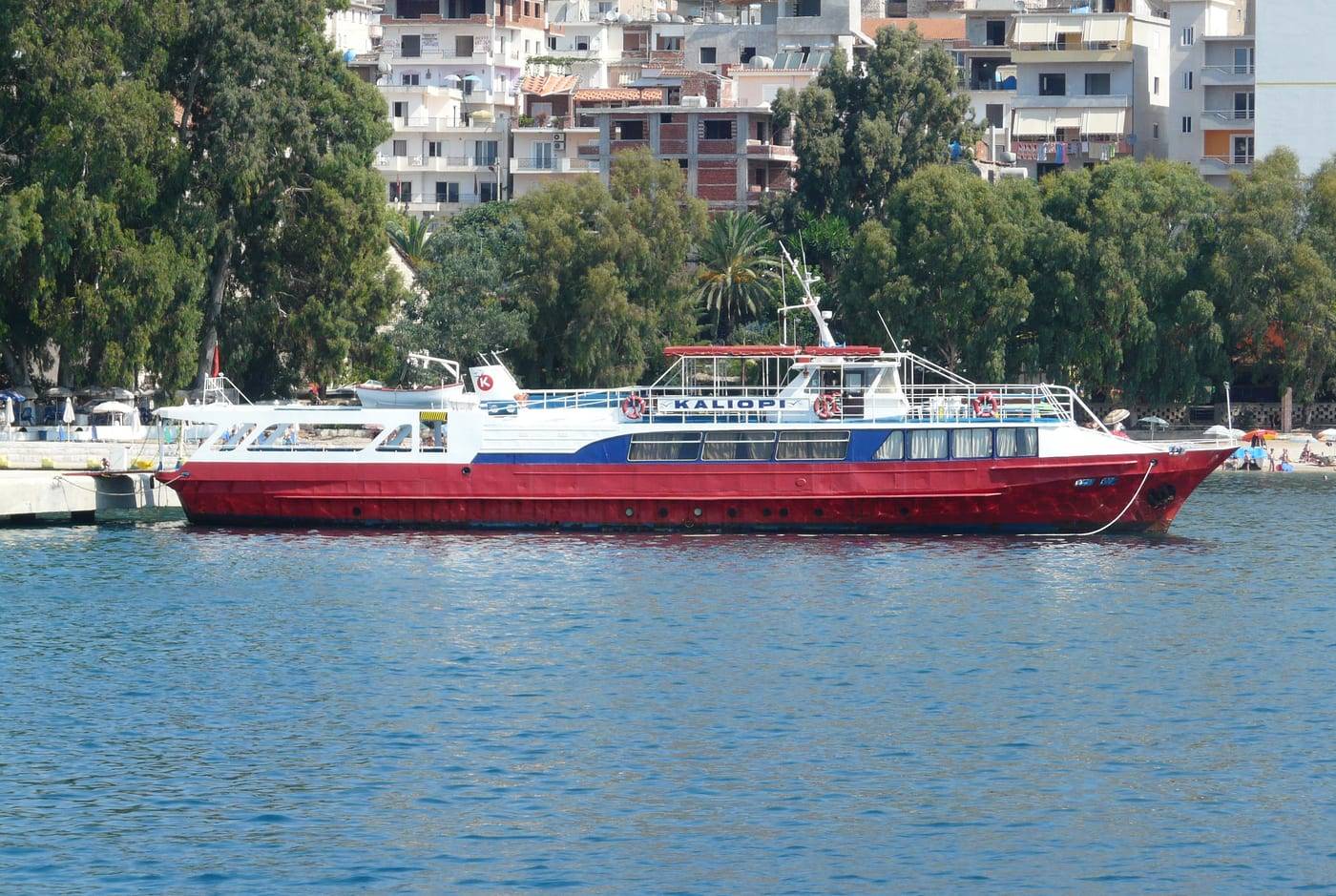 A passenger boat moored in Saranda harbour, with the town behind