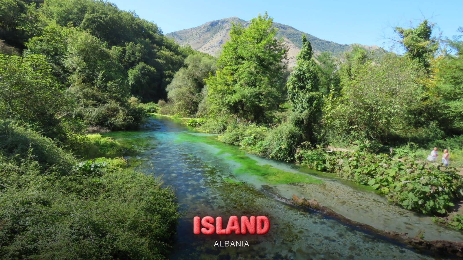 The Blue Eye spring (Syri i Kaltër) and its turquoise river among the trees, inland from Saranda, Albania, with the Party Island Albania logo